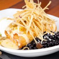 Chimichanga Pollo Verde · Crispy fried flour tortilla stuffed with shredded chicken and Mexican cheeses, topped with r...