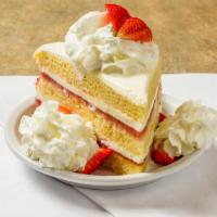 Strawberry Shortcake · Three layers of shortcake topped with fresh strawberries and whipped cream.
