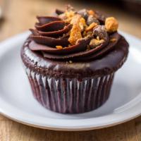 The Ron Bennington · chocolate cake, peanut butter filling, chocolate ganache and crushed butterscotch topping.