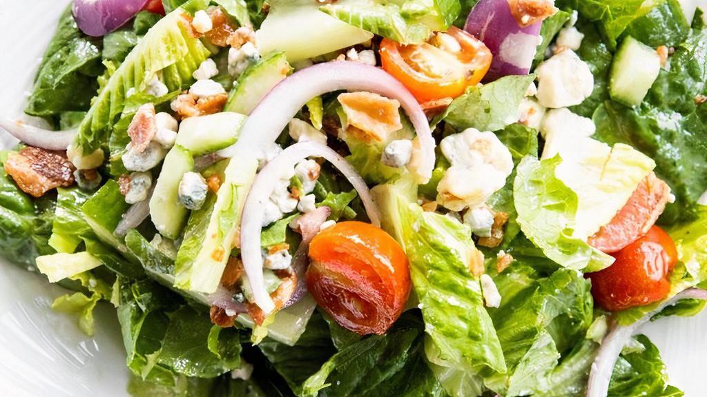 Chop Salad · Hearts of Romaine lettuce, tomato, cucumber, red onion, blue cheese, and bacon. Recommended dressing - our house-made apple cider vinaigrette.