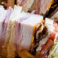 Piled High Club · Turkey, ham, bacon, cheddar, swiss, lettuce, tomato, onion, garlic aioli, and sourdough.