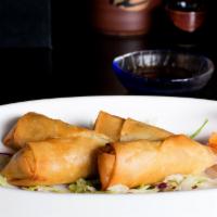 Shrimp Spring Rolls · Fresh shrimp, cabbage, mushroom, and carrot rolled in rice paper and crispy fried, with tang...