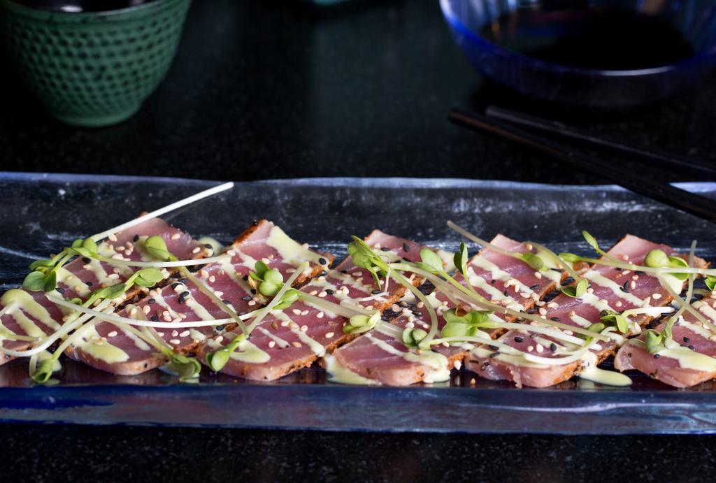 Tuna Carpaccio · Spicy.Fresh tuna seared cajun style served with a spicy horseradish sauce.