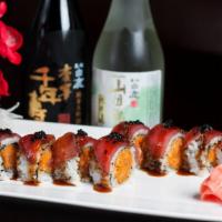 Black Samurai · Spicy yellowtail, slices of seared peppercorn tuna and masago on top with eel sauce.