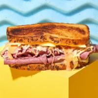 Reuben Sandwich · New York style corned beef with melted Swiss cheese, sauerkraut, and Russian dressing on rye...