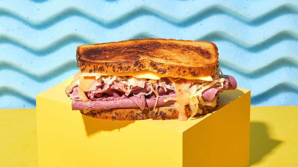 Reuben Sandwich · New York style corned beef with melted Swiss cheese, sauerkraut, and Russian dressing on rye bread.