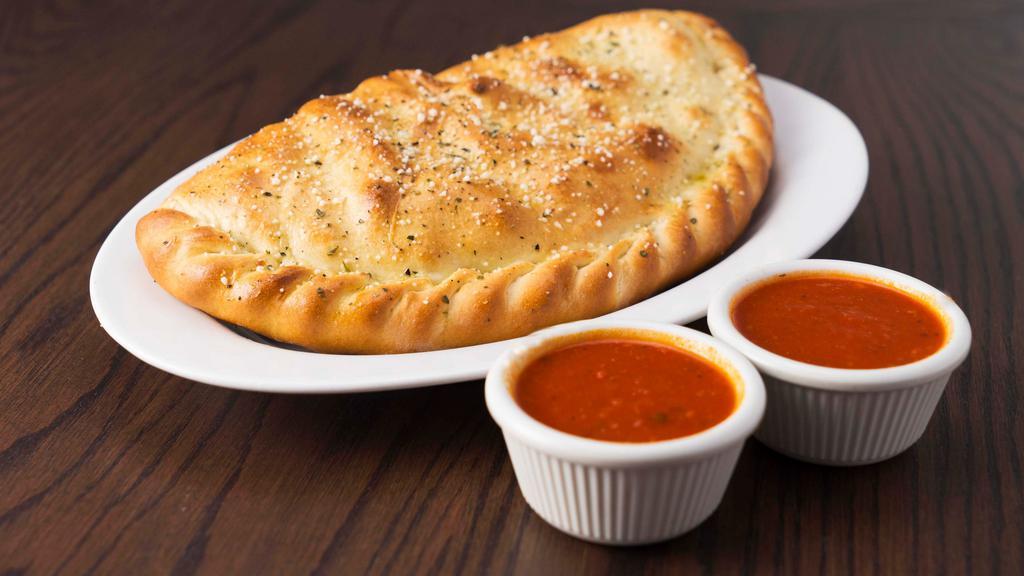 Calzone · Mozzarella cheese wrapped with butter-brushed dough, sprinkled with parmesan & oregano, then baked to perfection. Served with 2 cups of marinara sauce on side.