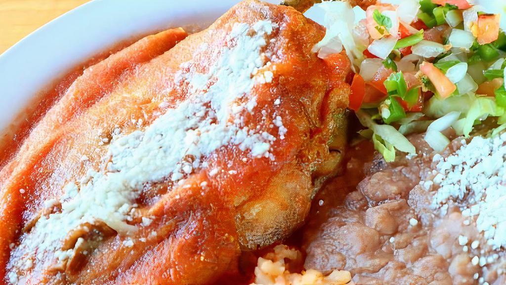 Chile Relleno · Roasted poblano pepper stuffed with queso fresco, topped with tomato sauce and served with rice, refried beans, and corn tortillas.