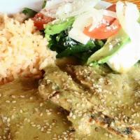 Mole Verde · Grilled chicken breasts coated with tomatillo sauce and served with rice, refried beans, cor...
