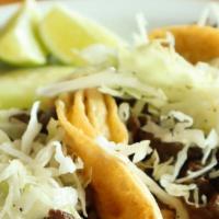 Mari'S Tacos · Three corn tortillas, refried beans, rice, steak meat, and shredded cabbage, served with mar...