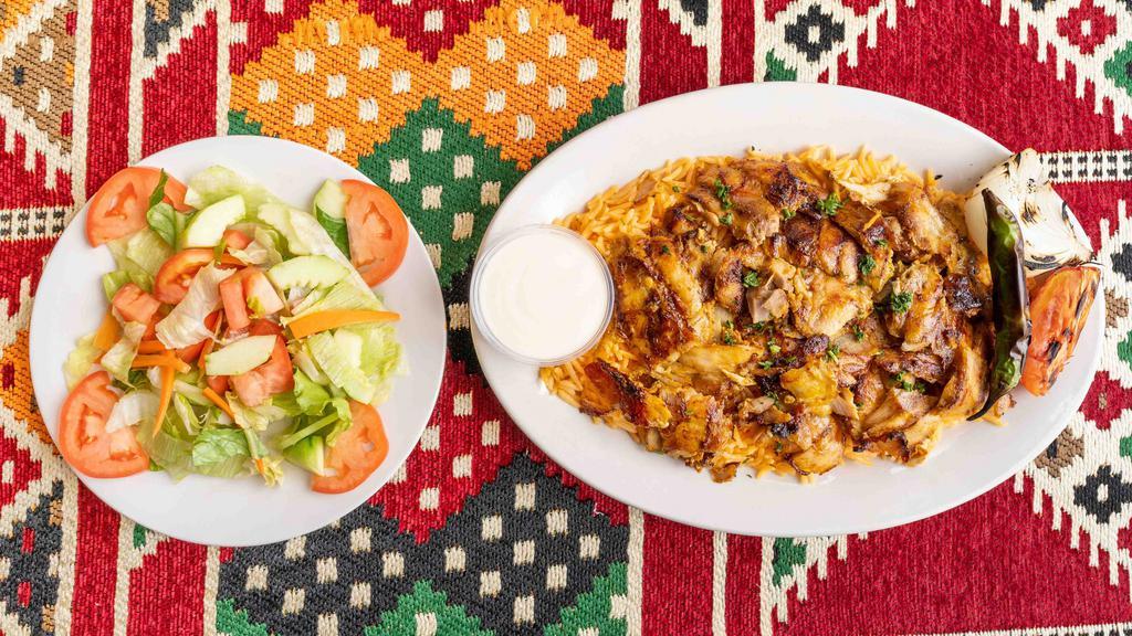 Chicken Shawarma Platter · Served with rice, grilled onion, pepper, tomato, Arabic salad and pita.