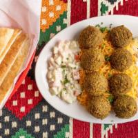 Mezze Platter · Vegetarian sampler. Includes hummus, baba ghanoush, falafel, stuffed grape leaves and taboul...