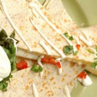 Quesadillas · Flour tortilla quesadilla filled with cheese, grilled onions and bell peppers. Served with s...