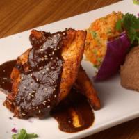 Pollo En Salsa · Grilled chicken breast simmered in your choice of salsa. Served with Mexican rice and re-fri...