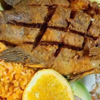 Mojarra Frita / Tilapia · Lubina plateada frita. Servido con arroz, ensalada y tortillas. / Deep fried silver bass. Se...