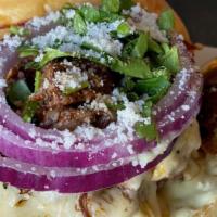 Birria Burger · Double Smash Burger, Pepperjack, Birria, Onion, Cilantro Aioli, Cotija, Consume