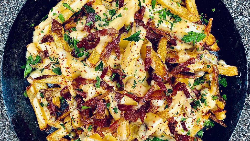 Loaded Fries · Crispy french fries topped them with our five-cheese sauce, crispy bacon pieces and chives.