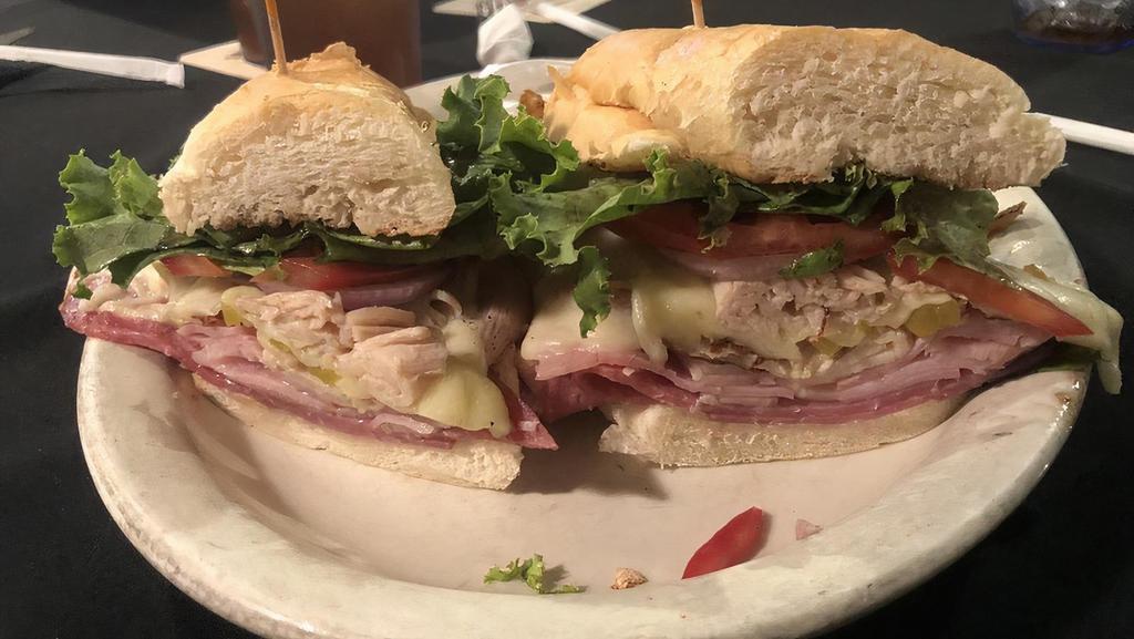 Italian Sub · Toasted hoagie, ham, turkey, salami, provolone cheese, banana peppers, lettuce, tomato, red onion and balsamic vinaigrette. Try it as a wrap!