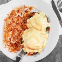 Eggs Florentine · Two poached eggs, spinach and tomato on toasted English muffin, topped with Hollandaise sauc...