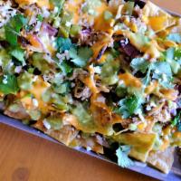 Carnitas Nachos · house cheese, cilantro, crema, grilled onions, pickled jalapenos