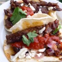 Asada Taco · 3 tacos. Corn tortilla, arbol salsa, grilled onions, cilantro, queso fresco, pico de gallo