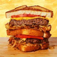 Burger Grilled Cheese · Melted cheddar cheese, beef burger patty, caramelized onions, tomato, and mayo between two s...