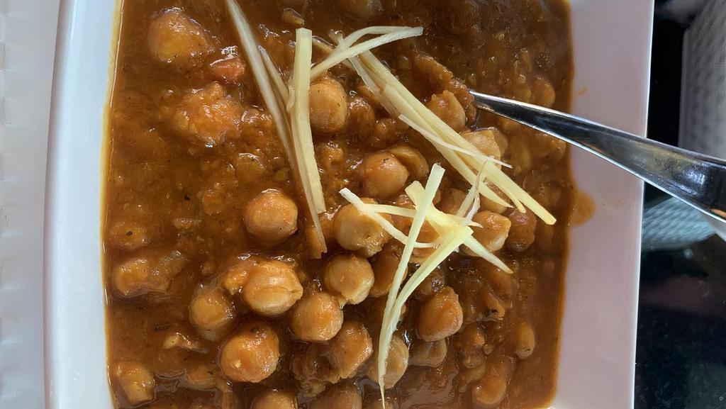 V-11. Punjabi Chana Masala · Chickpeas cooked in onion and tomato curry sauce.