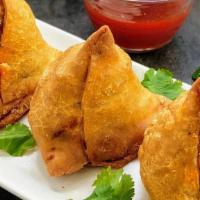 Beef Samosa  · Puff pastry filled with sautéed seasonal vegetables herbs, potatoes, and fried. Served with ...