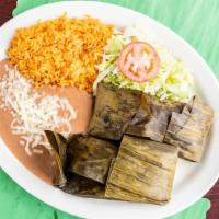 Tamales Oaxaqueñas Dinner · two chicken tamales wrapped in banana leaf