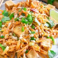 Pad Thai Tofu · Spicy. Thai rice noodle stir fried with bean sprouts, eggs, green onions and carrots. Tofu i...