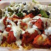 Chicken Tikka · served with rice and salad. The chicken tikka is bbq chicken with rice Indian spices served ...