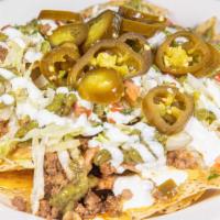Nacho · Includes cheese, refried beans, chile con queso, sour cream, crema verda, pickled jalapenos,...