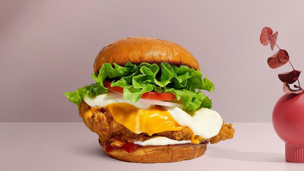 Cheese Fried Chicken Sandwich · Buttermilk fried chicken, cheddar, mozzarella, lettuce, tomato, red onion, mayo, and ketchup served on a griddled brioche bun.