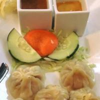 Steamed Mo Mo · Steamed dumplings, with minced vegetables, mixed with a blend of aromatic spices. Served wit...