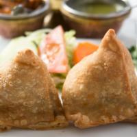 Chicken Samosa · Cone pastry stuffed with spiced minced chicken, served with mouthwatering mint and tamarind ...