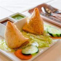Lamb Samosa · Cone pastry stuffed with spiced minced lamb, served with mouthwatering mint and tamarind chu...