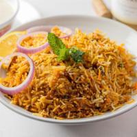 Chicken Biryani · Basmati rice infused with Saffron, richly flavored with herbs and spices cooked along with t...