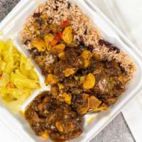 Large Jerk Chicken · Including red beans and rice with cabbage and plantains.