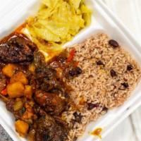 Large Brown Stew Chicken · Including red beans and rice with cabbage and plantains.