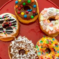 Gourmet Candy Topped Donuts · Candy toppings: 
Andes Mint, Butterfinger, Lucky Charms, Fruity Pebbles, Pecans, Oreo, Heath