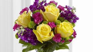 The Ftd Happy Times Bouquet · The FTD Happy Times Bouquet employs roses and stock to bring vibrant color and fragrance straight to their door on their special day. Yellow roses, purple stock, green button poms, fuchsia mini carnations and lush greens create a stunning display beautifully arranged in a clear gathered square glass vase to help you convey your happy birthday wishes or send your congratulations.