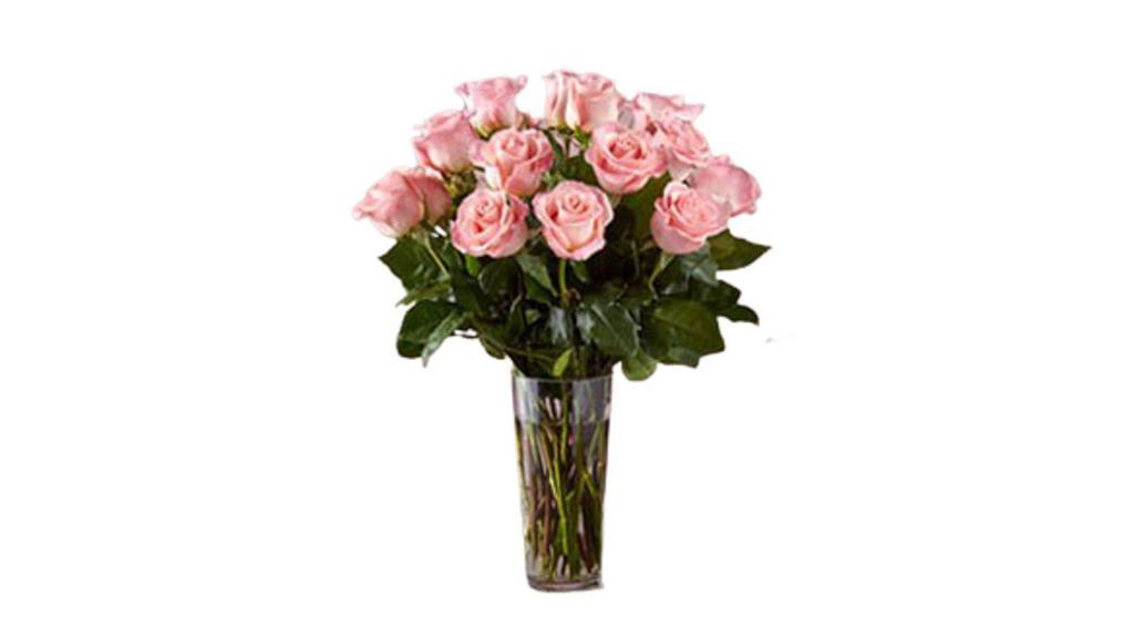 Long Stem Pink Rose Bouquet · Picture-perfect soft pink roses make a beautiful gift for the lovely lady in your life. Wife, mother, daughter or sweetheart, she's sure to cherish this bouquet of pastel pink roses accented with seeded eucalyptus and arranged in a clear glass vase.