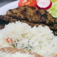 Carne Azada · Grilled ranchera steak, served with rice, beans, fresh salad and hand made corn tortillas.