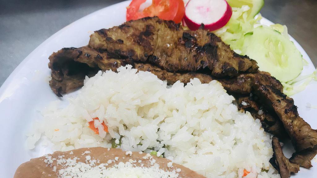 Carne Azada · Grilled ranchera steak, served with rice, beans, fresh salad and hand made corn tortillas.