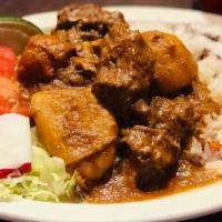 Carne Guisada · Beef stew, served with rice, beans, salad and fresh-made tortillas.