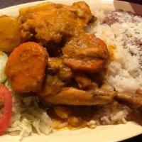 Pollo Guisado · Salvadorian chicken stew served with rice, beans and fresh salad.