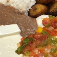 Huevos Rancheros · Two over-easy eggs topped with warm tomato sauce served with beans, rice and sour cream.