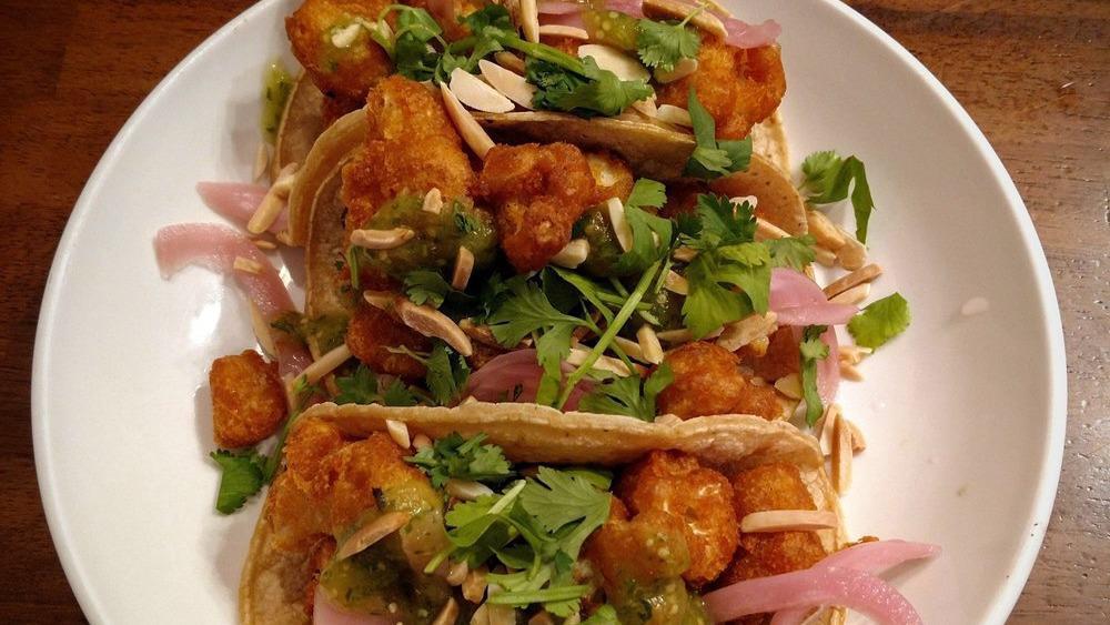 Cauliflower Tacos · Breaded cauliflower florets, roasted almonds, pickled red onion, and sweet tomatillo sauce; served on corn tortillas.