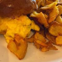 Soft Scramble Sandwich · Soft scrambled eggs on a brioche bun with spicy mayo, caramelized onions, bacon and Pepper J...