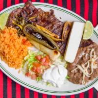 Tampiqueña · Grilled skirt steak or chicken breast topped with a cheese red enchilada served with rice an...